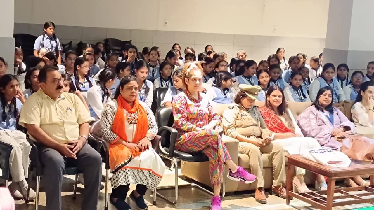 Audience and school students listening to health speakers in auditorium